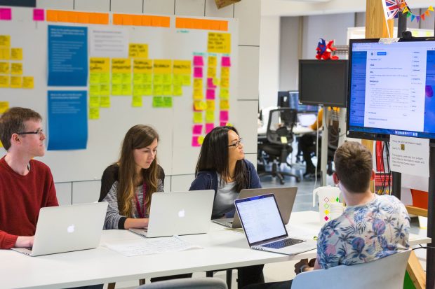 Four members of the Platform Health team looking at a screen.