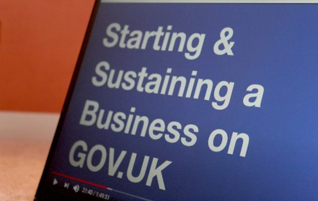 A laptop showing a presentation slide with the words “Starting & Sustaining a Business on GOV.UK.”