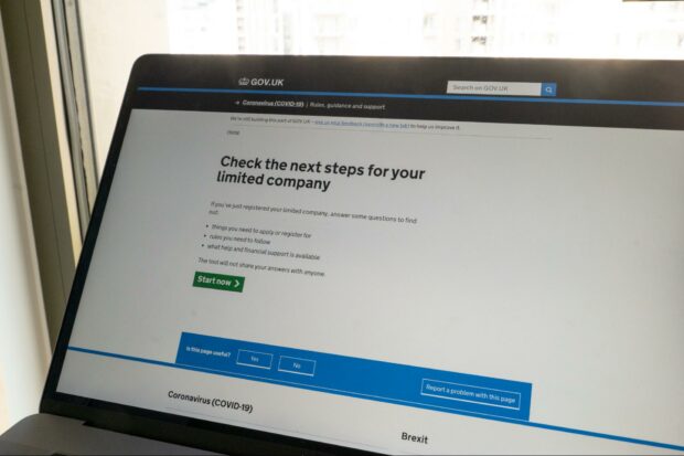 A laptop with “Check the next steps for your limited company” on its screen.