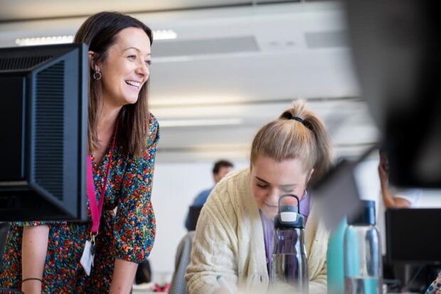 2 women at a desk in an office