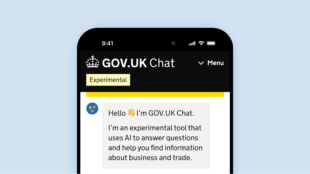 An image of the initial message seen by GOV.UK Chat users displayed on a smartphone, against a light blue background. The message says “Hello, I’m GOV.UK Chat. I’m an experimental tool that uses AI to help you find information about business and trade.”